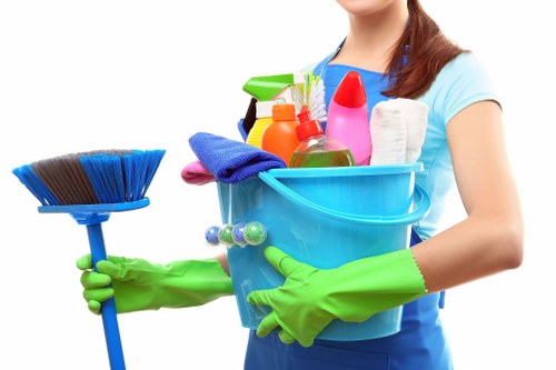 Cleaner following safe cleaning procedures with protective equipment